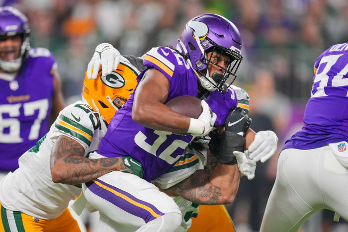 Dec 31, 2023; Minneapolis, Minnesota, USA; Minnesota Vikings running back Ty Chandler (32) runs with the ball against the Green Bay Packers in the first quarter at U.S. Bank Stadium.